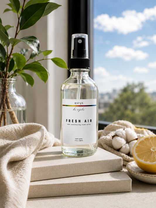 Room spray bottle labeled 'Fresh Air' on a surface with a window view