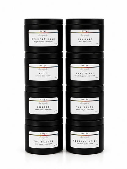 Set of black candles with labels in two stacks of four on a white background 