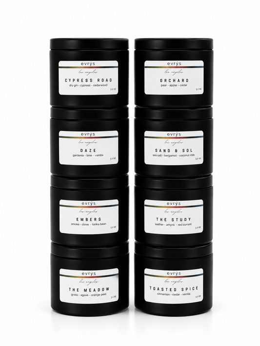 Set of black candles with labels in two stacks of four on a white background 