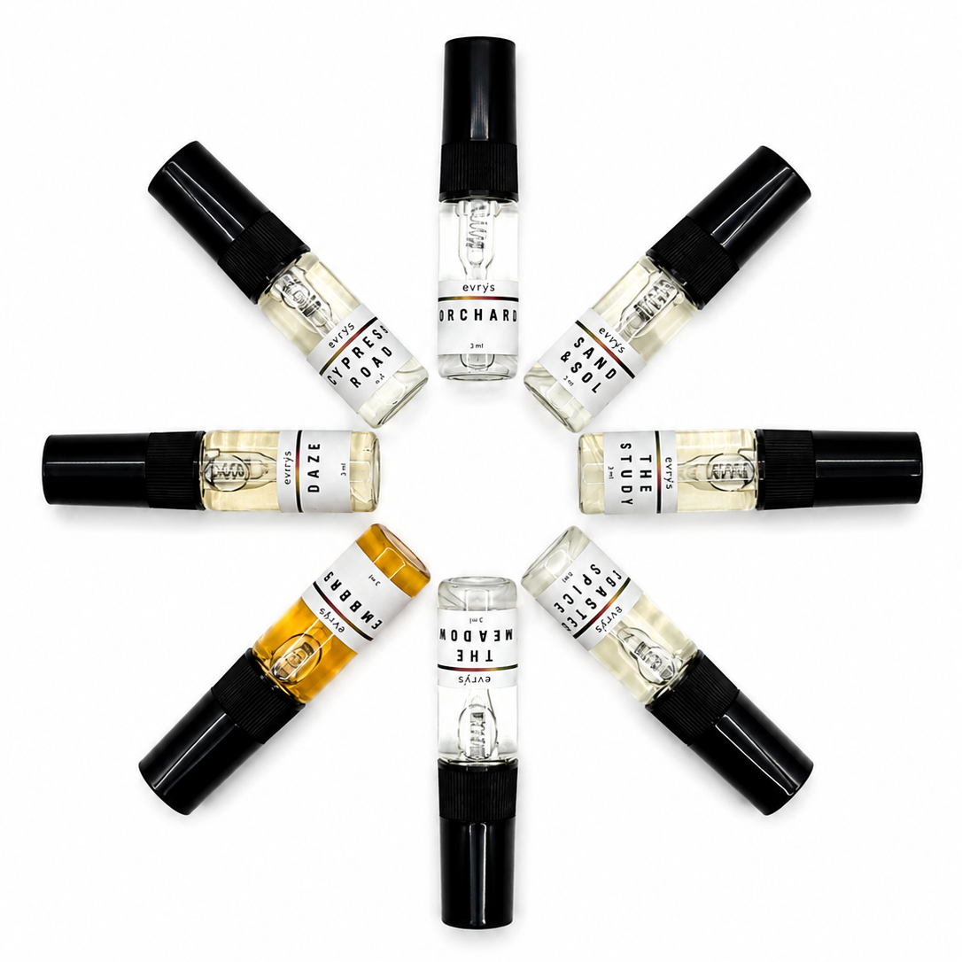 Set of small perfume bottles arranged in a circular pattern on a white background