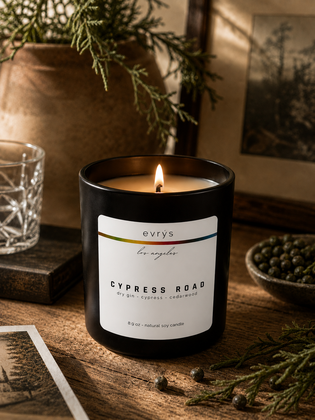 evrys candle labeled 'Cypress Road' on a wooden surface with decorative elements.