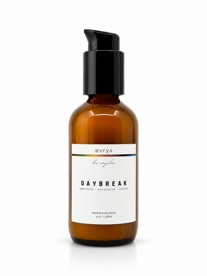 Amber glass lotion bottle with black  labeled 'evrys' Daybreak on a white backgroundump