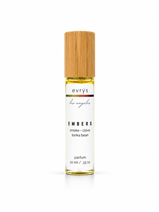 evrys Embers oil roller parfum bottle with a bamboo cap on a white background