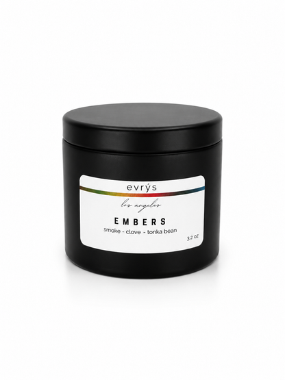 Black candle jar with an evrys Embers label on a white background