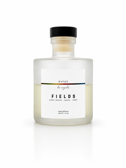 Glass reed diffuser bottle labeled 'Fields' by evrys on a white background