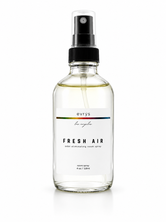 Glass room spray bottle with black spray nozzle labeled 'evrys los angeles' FRESH AIR on a white background