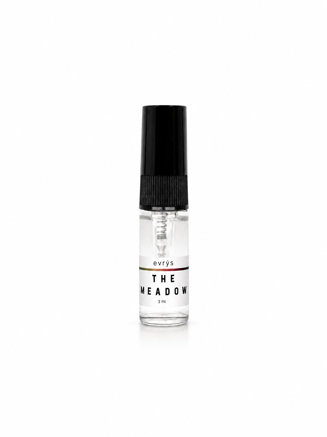 Small glass bottle with an evrys The Meadow label and a black cap on a white background