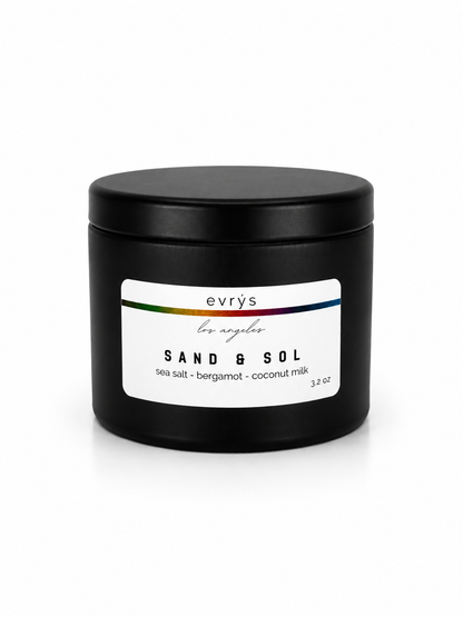 Black candle jar with 'evry's Los Angeles' Sand & Sol label on a white background