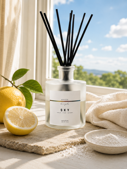 Reed diffuser labeled 'SKY' with lemons and a scenic background