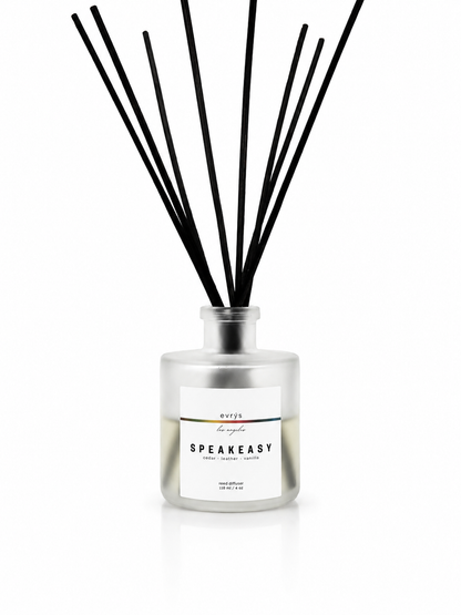 Speakeasy diffuser with black reeds on a white background