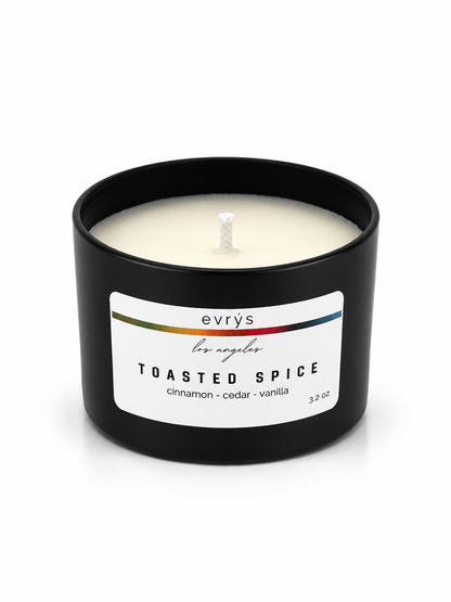 Evrys toasted spice candle in a black container on a white background