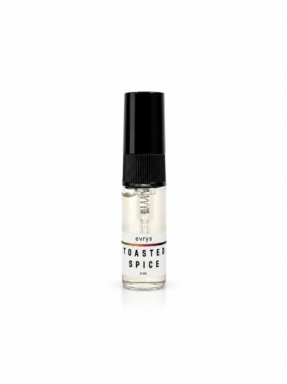 Small glass fragrance bottle labeled 'Toasted Spice' with a black cap on a white background